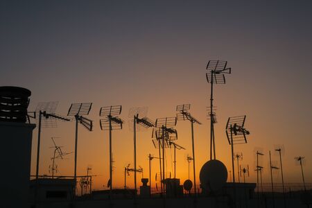 Antenna on the roof in silhouetteの写真素材