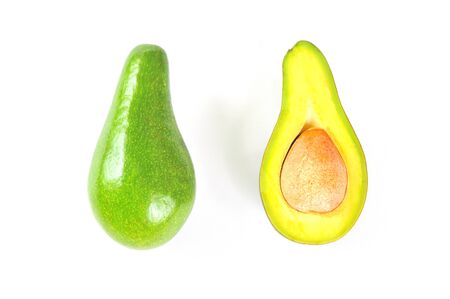 Half sliced avocado and whole isolated on white background. Top view.