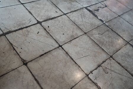 Old dirty grunge tile floor with reflected from light bulbの写真素材