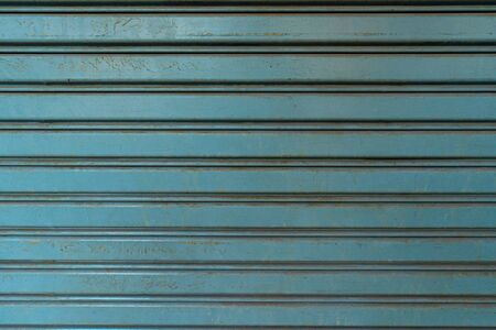 Horizontal corrugated fence of blue metal sheets. Texture of metal fence picket profile decking.の写真素材