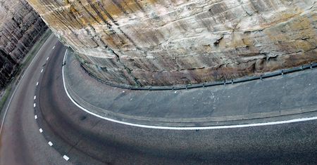 road curve, stone walls on both sidesの写真素材