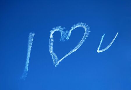 blue sky, white text created with a jet: I LOVE Uの写真素材