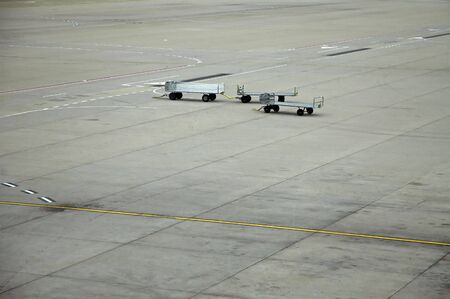 airport scene, three luggage trolleys, grey concreteの写真素材