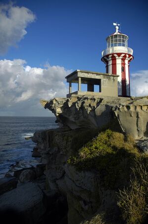 red and white lighthouse in Sydney, Watson Bay, ocean in backgroundの写真素材