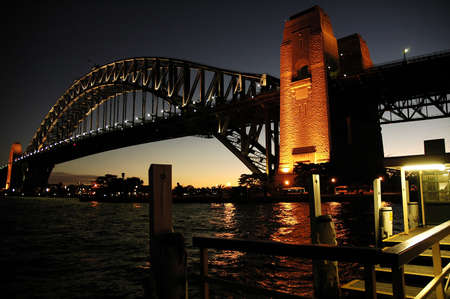 Harbour Bridge in Sydney; night scene; wooden wharf in foregroundの写真素材