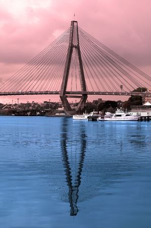 colored picture of Anzac Bridge in Sydney, blue reflection in water, red skyのeditorial素材
