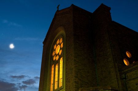 church in sydney at night, illuminated from inside, moon in backgroundの写真素材
