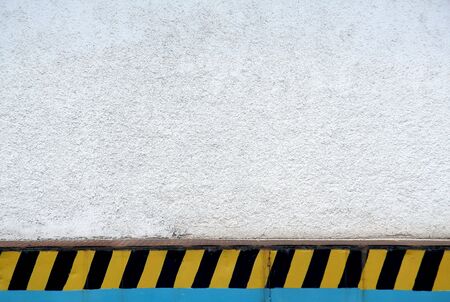 simple industrial background, white wall, black and yellow stripsの写真素材
