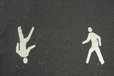 two way pedestrian walkway symbols on dark grey asphalt backgroundの写真素材