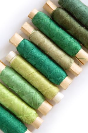 several green stitches on tubes isolated on white backgroundの写真素材