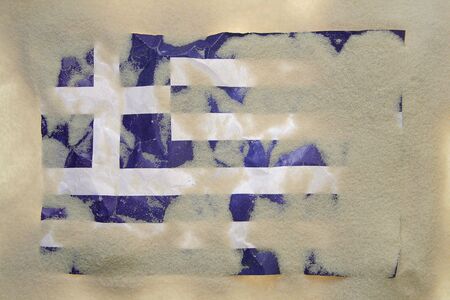 greek flag covered with sandの写真素材