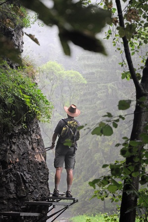 22. JULY 2010 - SLOVENSKY RAJ, SLOVAKIA - a man standing on steel steps in slovak national par - Slovensky raj. Photo taken on 22 July 2010.のeditorial素材