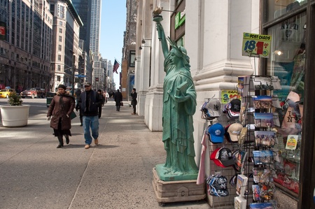28. MARCH 2011 - MANHATTAN, NEW YORK CITY, USA - replica of The Statue of Liberty in front of a shop...