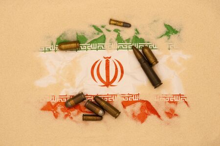 Iran flag covered in sand with different ammunition scatter on it