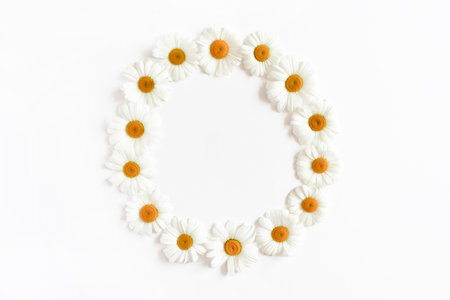 Wreath made of chamomile flowers on a white backgroundの写真素材