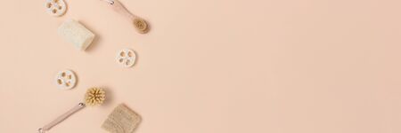 Layout of brushes made of bamboo and loofah on a beige background. Zero waste concept with place for text.の写真素材