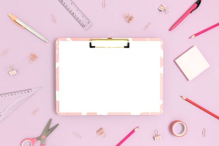 Top view of clipboard mockup and various stationery on a purple pastel background. Back to school concept.の写真素材