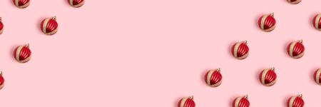 Frame made of Christmas balls pattern on a pink background. Banner with copy space.の写真素材