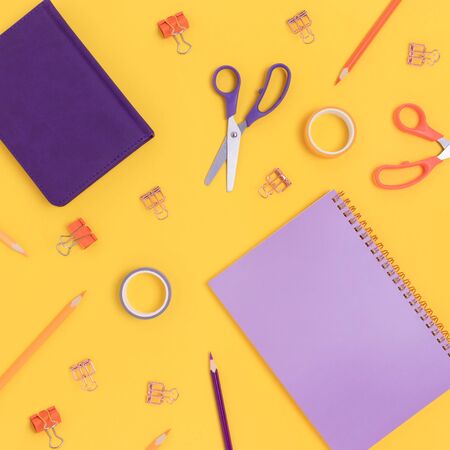 Pattern made of colorful office supplies on a bright yellow background. Creative school concept.の写真素材