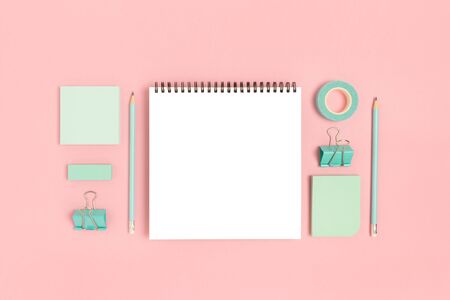 Notepad template with mint stationery on a pink pastel background. Creative mockup.の写真素材