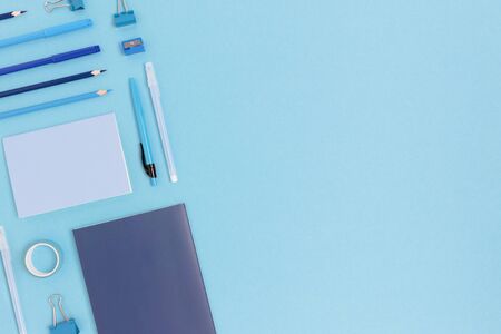 Layout of office supplies on a blue pastel background. Monochrome creative concept with place for...