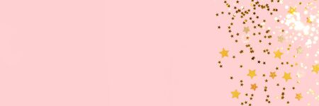 Banner with golden stars confetti on a pink pastel background. Shiny composition with copy space.