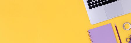 Banner with laptop, glasses, notepad and stationery on a bright yellow background. Student workspace...