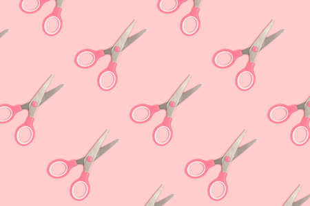 Scissors pattern on a pink pastel background. Monochrome composition.の写真素材