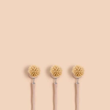 Bamboo brushes on a beige background. Plastic free concept with copy space.