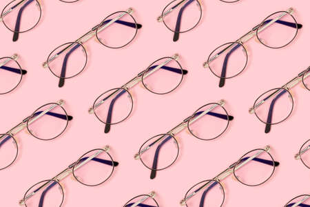 Eyeglasses pattern on a pink pastel background. Fashion accessories layout.の写真素材