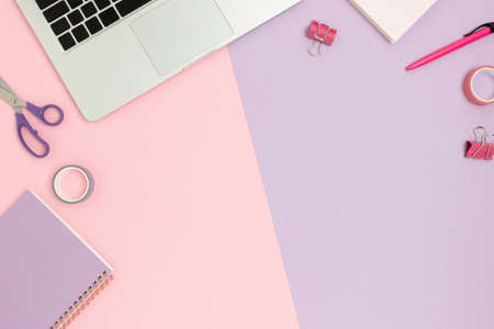 Top view of workspace on a colorful background. Composition with laptop and cute stationery.の写真素材