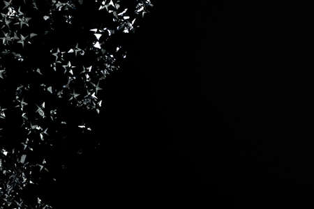 Silver stars confetti on a black background. Festive backdrop with place for text.の写真素材