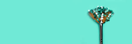 Paint brush with stars glitter on a turquoise backgroud. Banner with place for text.の写真素材