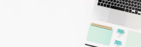 Workspace layout with laptop and office supplies. White banner with place for your design.