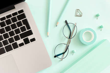 Composition with laptop, glasses and stationery on the mint tableの写真素材