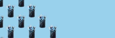 Metal buckets with various stationery pattern on a blue pastel background. Back to school banner...