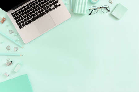 Border frame made of laptop and stationery on the mint tableの写真素材