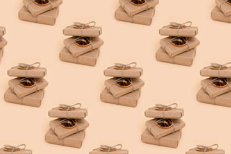 Pile of gift boxes pattern on a beige background. Christmas minimal preparationistic concept.
