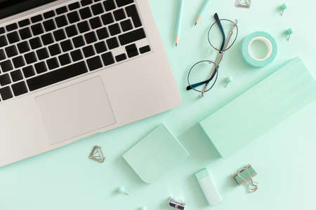 Composition with laptop, glasses and stationery on the mint tableの写真素材