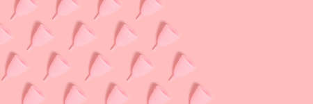 Banner with menstrual cups pattern on a pink background. Monochrome zero waste concept with copy space.の写真素材