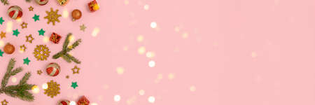 Banner with Christmas decorations pattern and shiny bokeh on a pink background. Festive concept with...