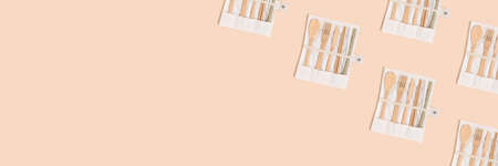 Pattern made of bamboo cutlery in a case on a beige background. Zero waste creative banner with copy...