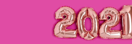 Header with 2021 made from rose gold color balloons on a magenta background with place for your design.の写真素材