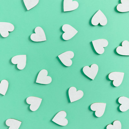 Pattern made of white hearts on mint backgroundの写真素材