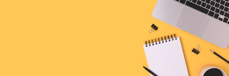 Banner with homeschooling workspace with laptop and stationery on a yellow background. E-learning...