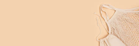 Banner with reusable textile bags on a beige background. Zero waste concept with copyspace.