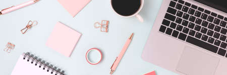 Banner with laptop and scattered office supply on a blue background. Distance education, online business, remote work concept.の写真素材