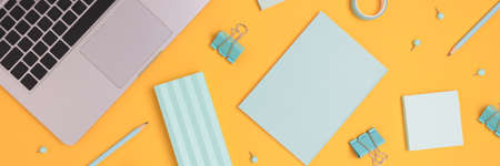 Header with laptop and scattered stationery on a yellow background. Online school, distance...
