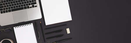 Banner with laptop and office supply on a black background. Online business organized workspace,...