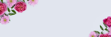 Banner with frame made of aster, rose flowers and green leaves on a blue background. Gentle floral concept with copyspace.の写真素材